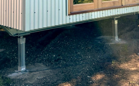 Pictured: Installed steel skid with legs attached to footings